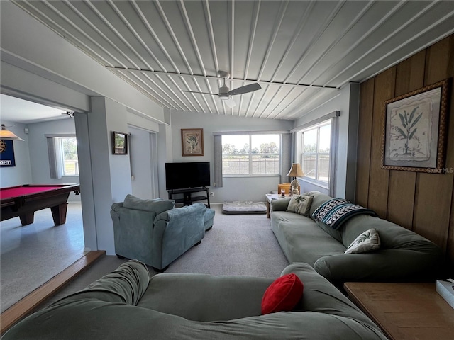 living room featuring a ceiling fan, wood walls, billiards, and a wealth of natural light