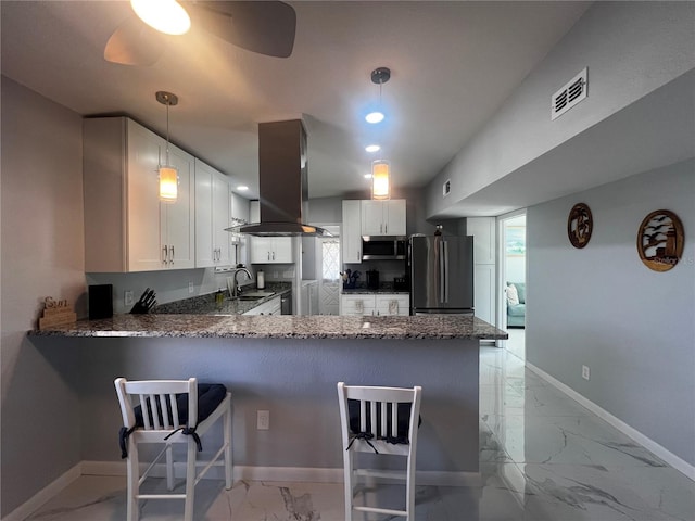 kitchen featuring island exhaust hood, a sink, marble finish floor, dark stone counters, and stainless steel appliances