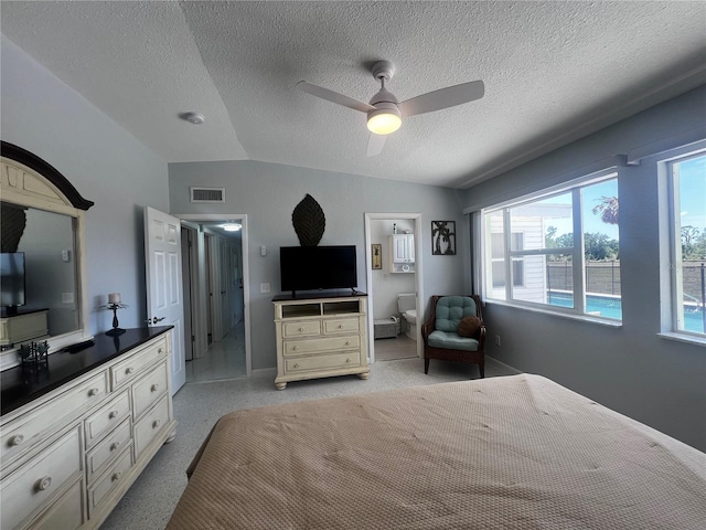 bedroom with a ceiling fan, a textured ceiling, visible vents, and ensuite bathroom