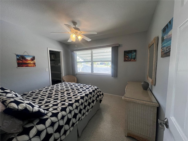 bedroom featuring ceiling fan and a textured ceiling