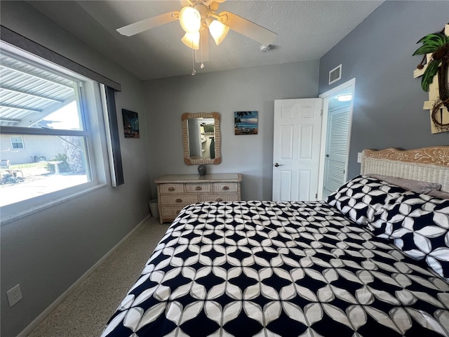 bedroom with visible vents, baseboards, and ceiling fan