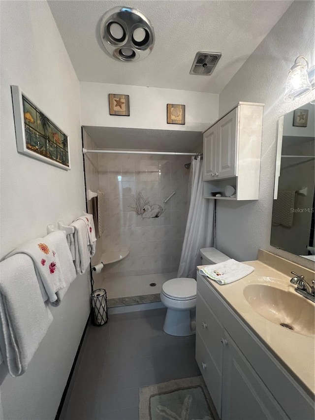 full bath with visible vents, vanity, toilet, a textured ceiling, and a stall shower