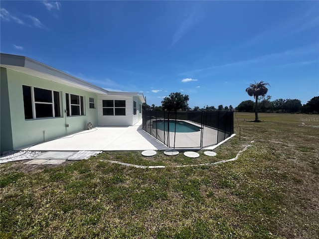 view of pool featuring a lawn, a patio, a fenced in pool, and fence
