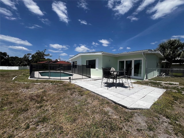 rear view of house featuring a patio area, a fenced in pool, a fenced backyard, a yard, and stucco siding