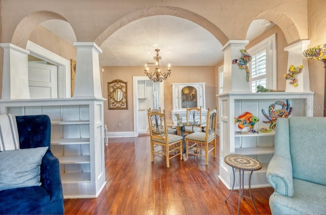 2002 Central Ave, Sarasota, FL 34234 - dining space featuring wood-type flooring, arched walkways, a chandelier, and decorative columns