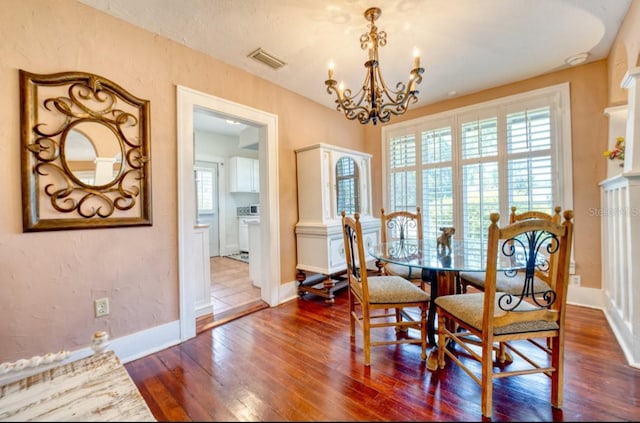2002 Central Ave, Sarasota, FL 34234 - dining space with dark wood finished floors and a chandelier
