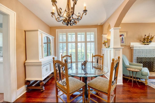 2002 Central Ave, Sarasota, FL 34234 - dining area with hardwood / wood-style floors, arched walkways, a chandelier, and a fireplace