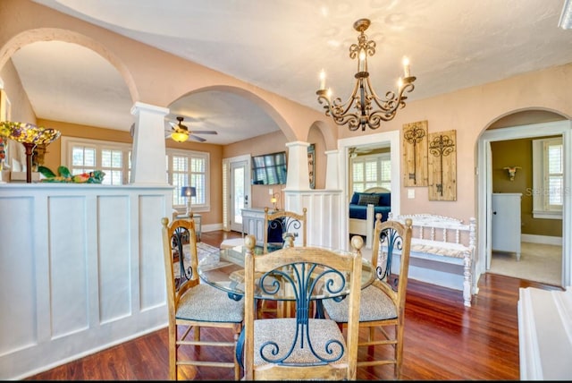 2002 Central Ave, Sarasota, FL 34234 - dining space featuring arched walkways, dark wood-style flooring, plenty of natural light, and a chandelier