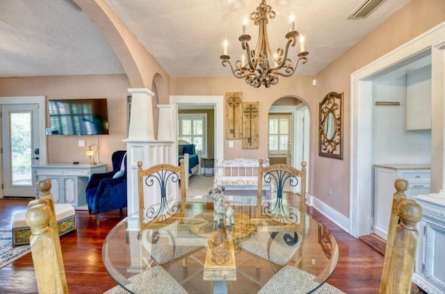2002 Central Ave, Sarasota, FL 34234 - dining room featuring arched walkways, wood finished floors, and a chandelier