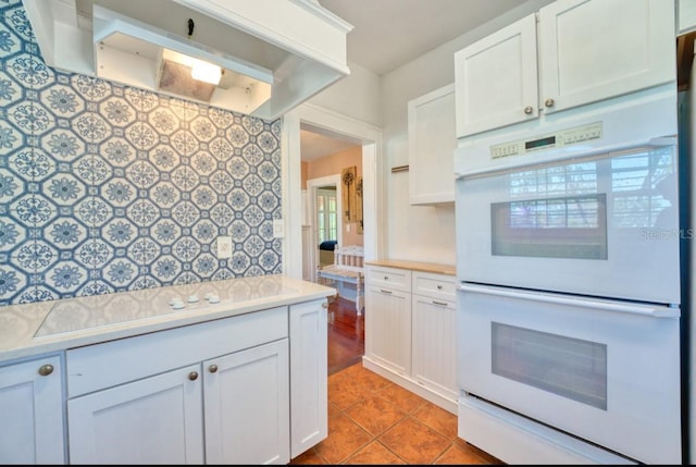 2002 Central Ave, Sarasota, FL 34234 - kitchen with double oven, custom exhaust hood, light countertops, and white cabinetry