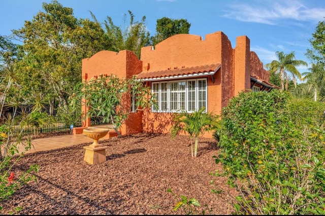 2002 Central Ave, Sarasota, FL 34234 - view of front of property with stucco siding, a patio area, and a tiled roof