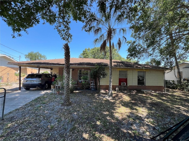 single story home with driveway and an attached carport