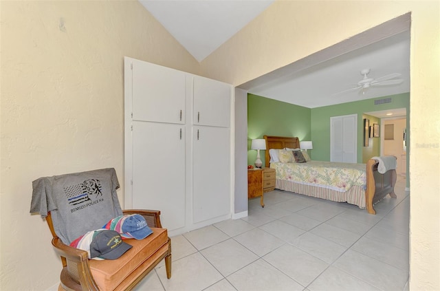 bedroom featuring light tile patterned flooring, lofted ceiling, and ceiling fan