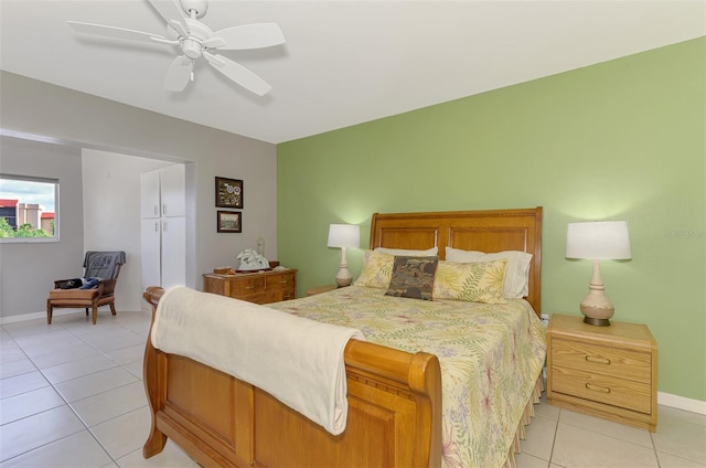 bedroom featuring light tile patterned floors, baseboards, and ceiling fan
