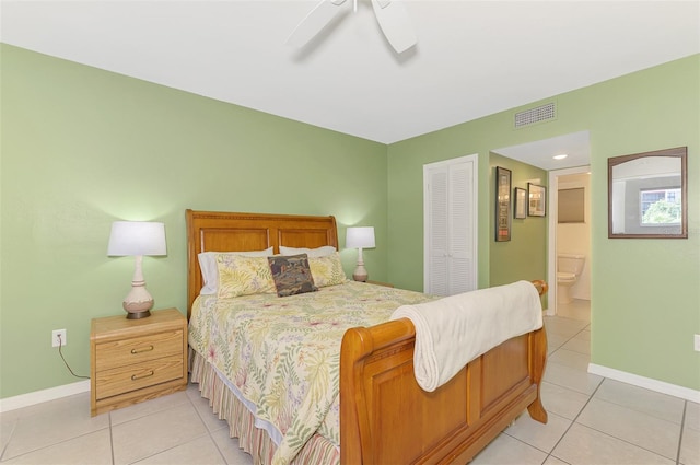 bedroom featuring light tile patterned floors, a closet, baseboards, connected bathroom, and a ceiling fan