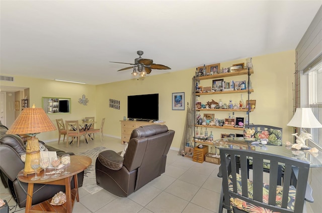 living room with a ceiling fan and light tile patterned floors
