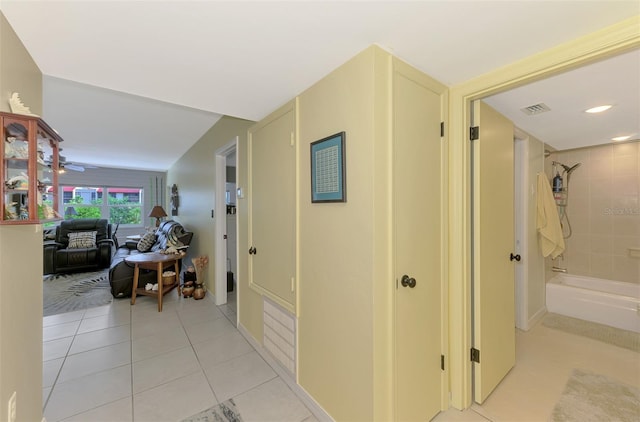hall featuring light tile patterned flooring