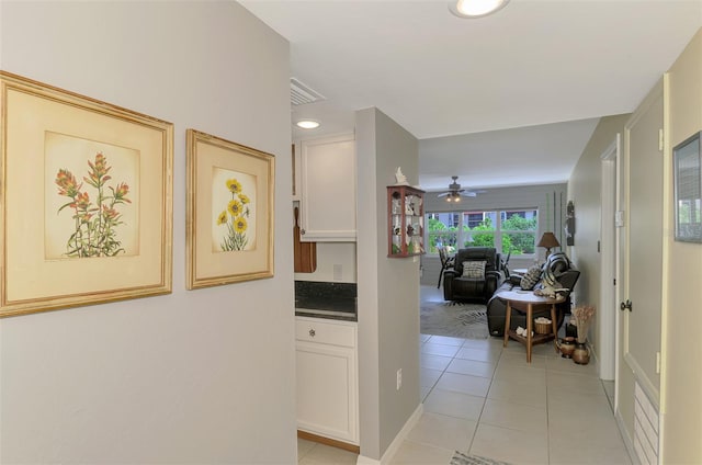 hall featuring light tile patterned flooring