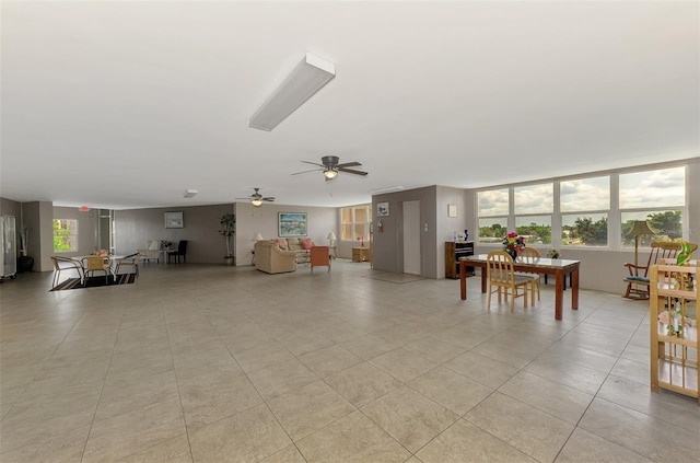 living area featuring a ceiling fan and light tile patterned flooring