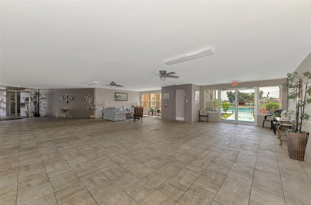 unfurnished living room with a ceiling fan