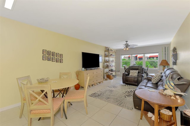 living room with a ceiling fan and light tile patterned flooring