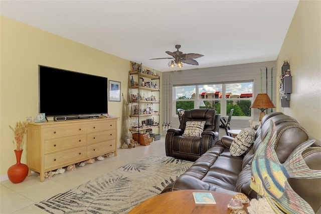 living area featuring tile patterned flooring and a ceiling fan