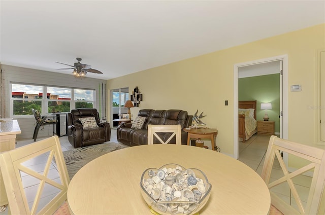 dining space featuring ceiling fan and light tile patterned floors
