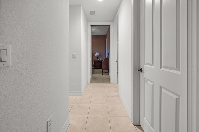 95 Vivante Blvd # 9524, Punta Gorda, FL 33950 - hall featuring baseboards, a textured wall, light tile patterned flooring, and visible vents