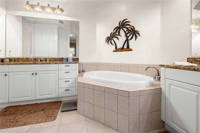 95 Vivante Blvd # 9524, Punta Gorda, FL 33950 - bathroom featuring visible vents, tile patterned flooring, two vanities, and a garden tub