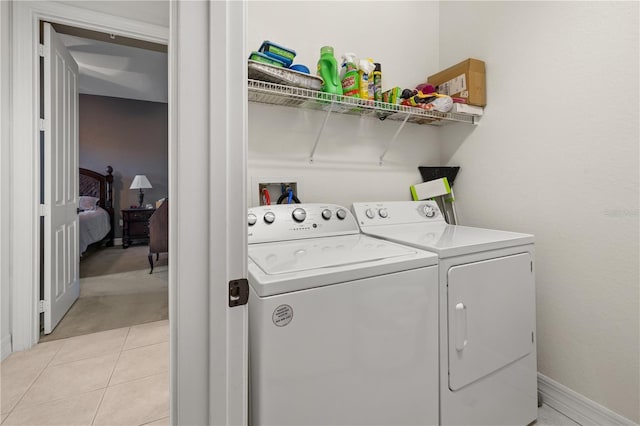 95 Vivante Blvd # 9524, Punta Gorda, FL 33950 - clothes washing area featuring laundry area, washing machine and dryer, light tile patterned flooring, light carpet, and baseboards