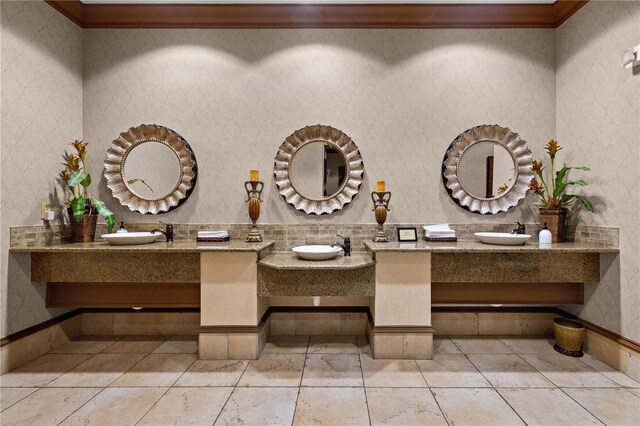 95 Vivante Blvd # 9524, Punta Gorda, FL 33950 - bathroom featuring two vanities, ornamental molding, and a sink