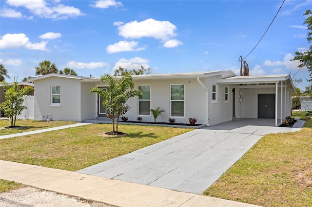 6309 Pontiac Ln, North Port, FL 34287 - ranch-style house with stucco siding, driveway, a front yard, and a carport