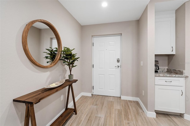 entryway featuring light wood-style flooring and baseboards