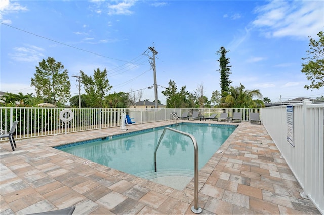 community pool featuring fence and a patio