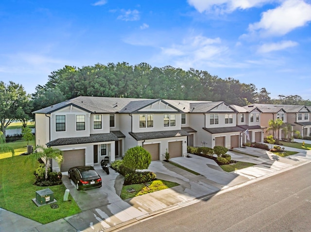 townhome / multi-family property with a garage, driveway, a residential view, and cooling unit