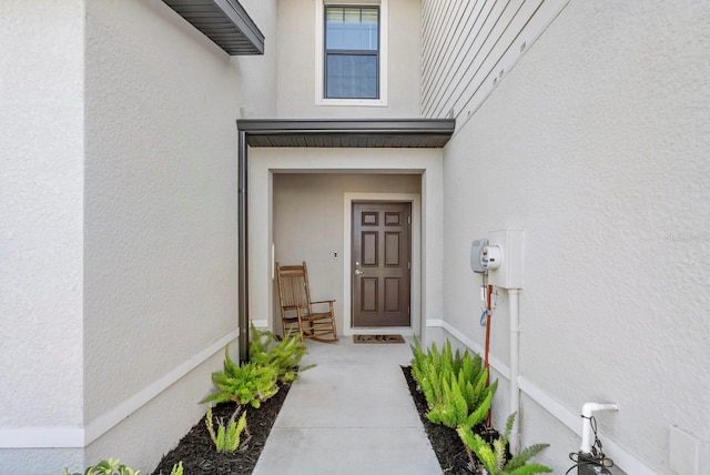 doorway to property with stucco siding