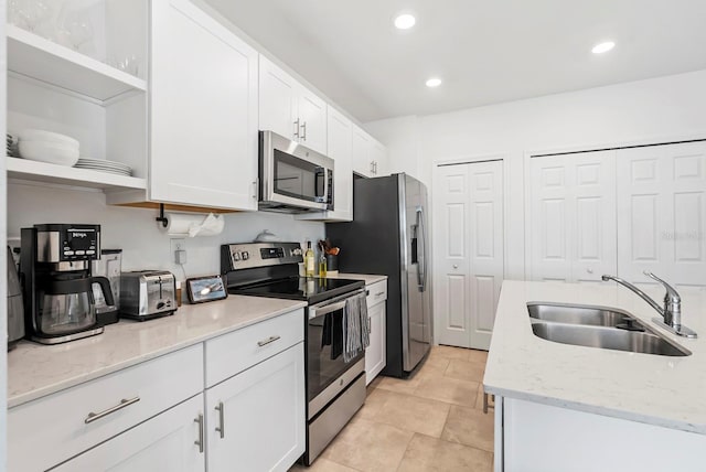 kitchen with open shelves, recessed lighting, white cabinets, a sink, and stainless steel appliances