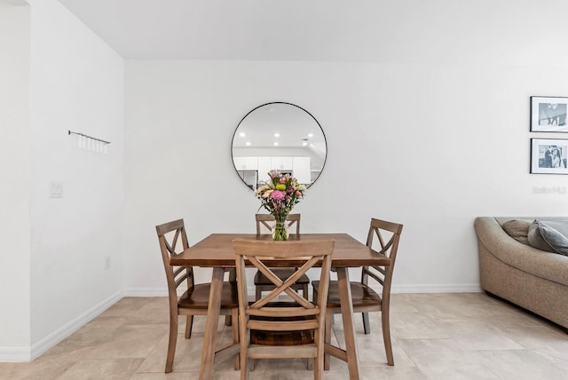 dining space featuring baseboards