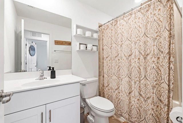 bathroom with vanity, shower / tub combo, and toilet