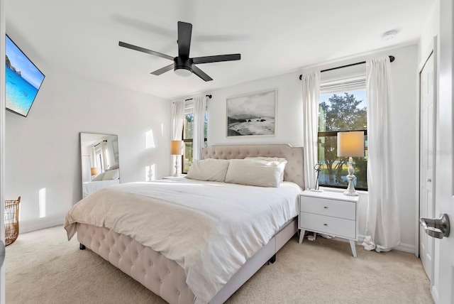 bedroom with ceiling fan and light colored carpet