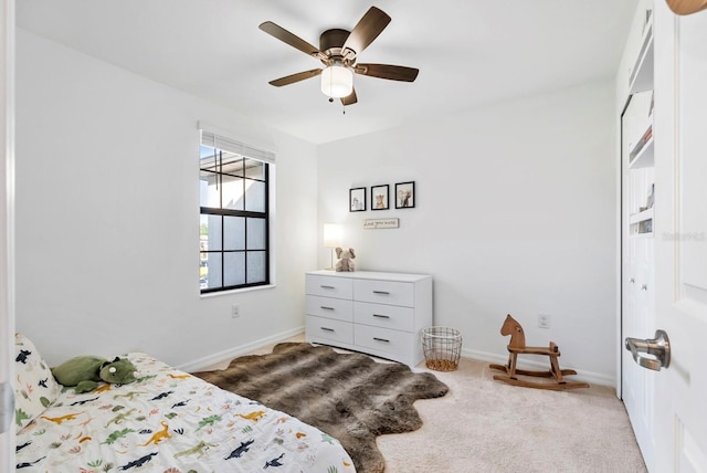 carpeted bedroom with baseboards and ceiling fan