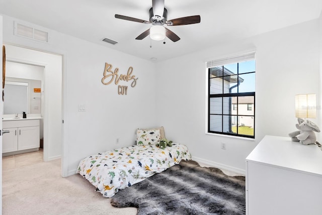bedroom with baseboards, light colored carpet, and visible vents