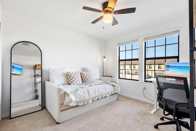carpeted bedroom with baseboards and ceiling fan