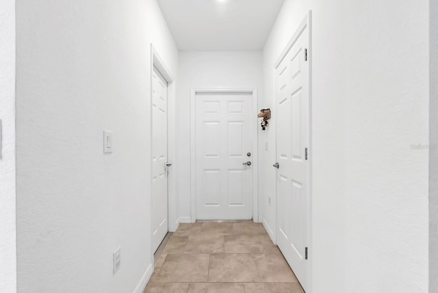corridor featuring baseboards