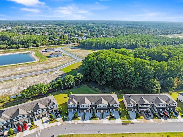 drone / aerial view featuring a forest view and a residential view