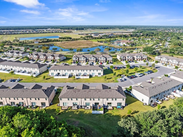 birds eye view of property featuring a water view and a residential view