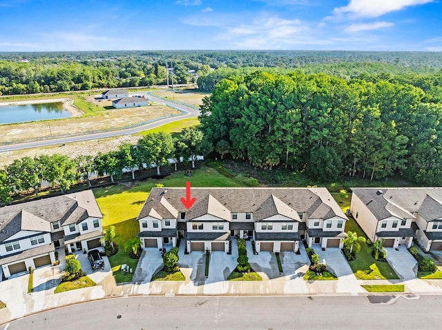bird's eye view featuring a water view, a residential view, and a forest view