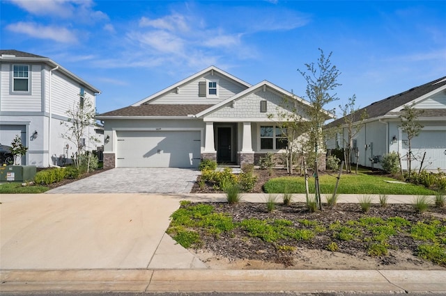 16029 Mulrion Blvd, Punta Gorda, FL 33982 - craftsman-style house with an attached garage, decorative driveway, and stone siding