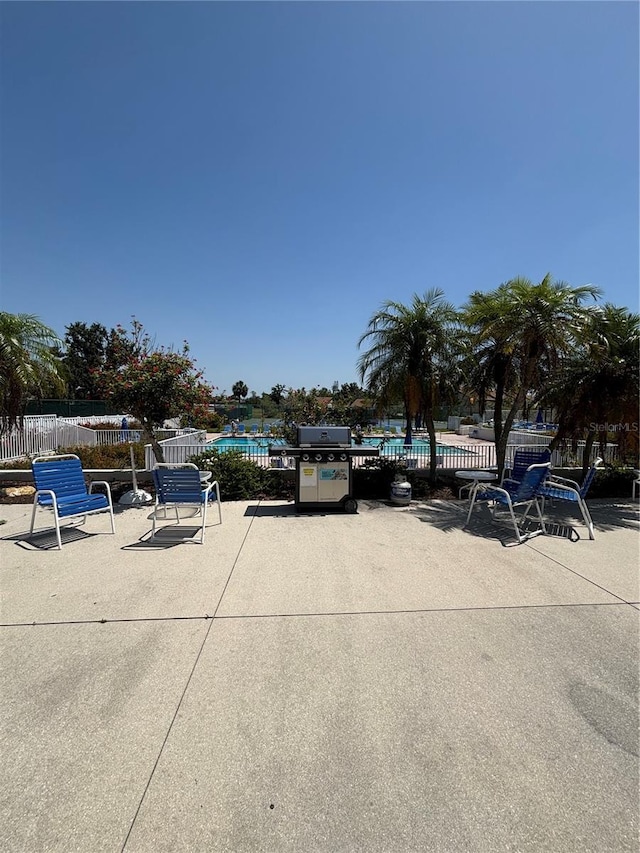 618 Bird Bay Dr S Unit 109, Venice, FL 34285 - view of parking featuring fence and a community pool