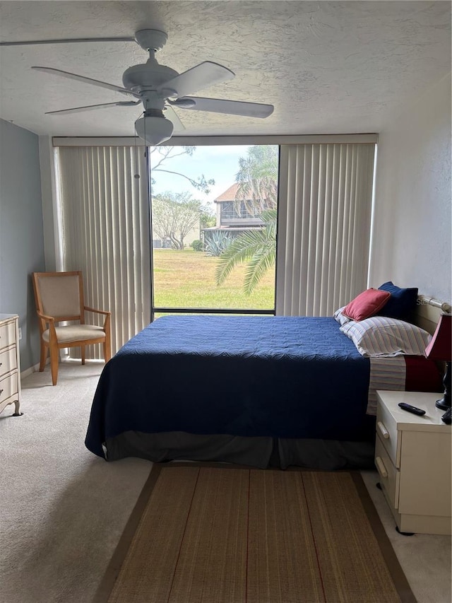 618 Bird Bay Dr S Unit 109, Venice, FL 34285 - bedroom featuring light colored carpet, ceiling fan, and a textured ceiling